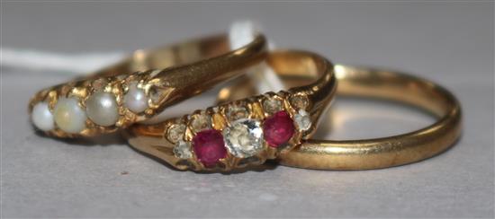 A 9ct gold wedding band and two 18ct gold rings including ruby and diamond.